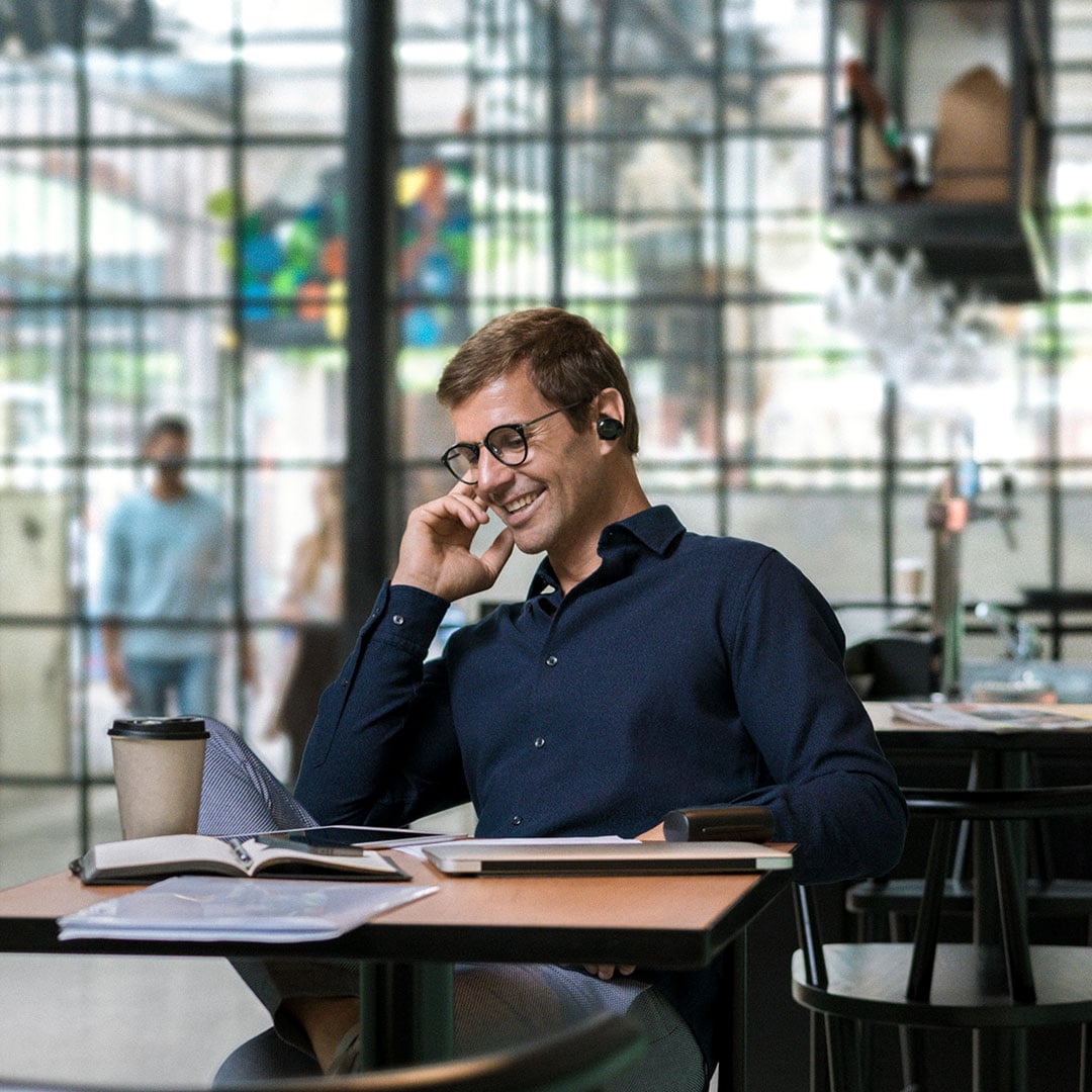 Business man talking into bluetooth headset