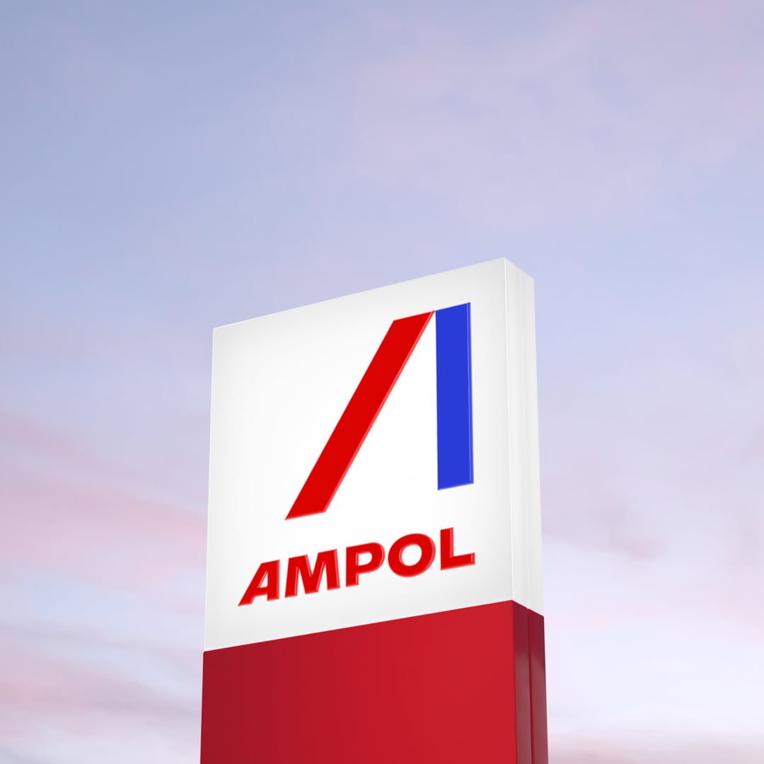 An Ampol sign stands in front of a pink purple sky.